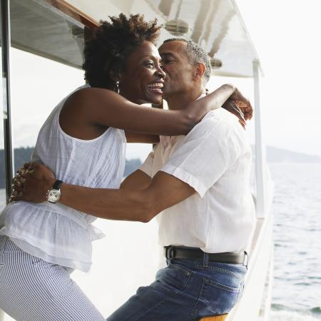 Couple hugging on boat. Financial and Estate Planning Seminars. Sandy Spring Trust.